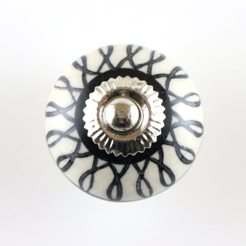 Ivory/black ceramic pull with hand painted loopy pattern