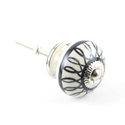 Ivory/black ceramic pull with hand painted loopy pattern