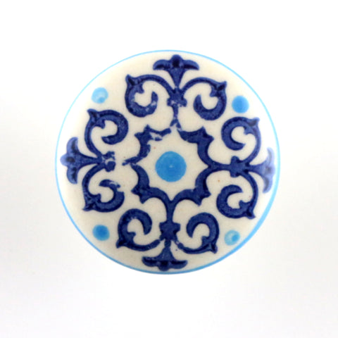 White ceramic pull with navy and turquoise scrolly pattern